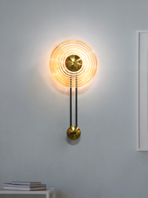 Load image into Gallery viewer, Modern Golden Pendulum-Style Steel And Round Amber Glass Decorative LED Wall Lamp placement in home
